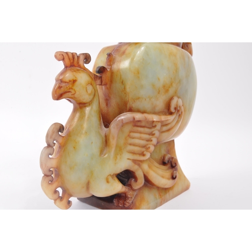 314 - An early 20th century Chinese carved soapstone vase. The vase having anthropologic carved phoenix an... 