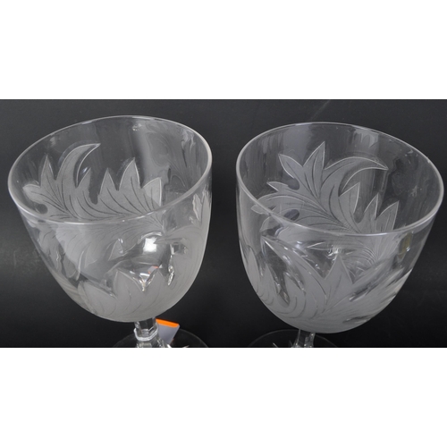 32 - A pair of 20th Century acid etched wine drinking glasses. Having foliate embossed pattern to taperin... 