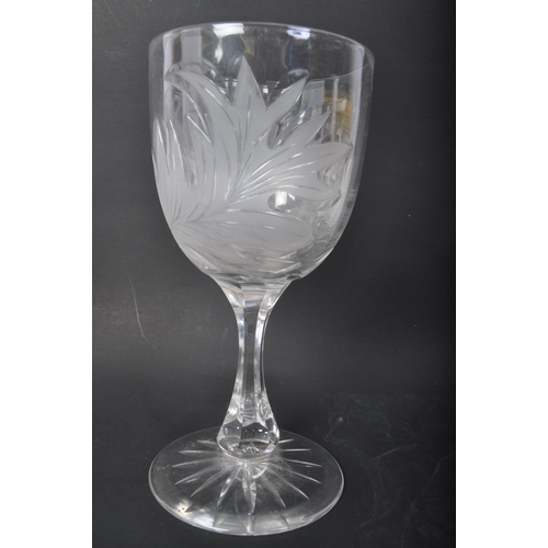 32 - A pair of 20th Century acid etched wine drinking glasses. Having foliate embossed pattern to taperin... 