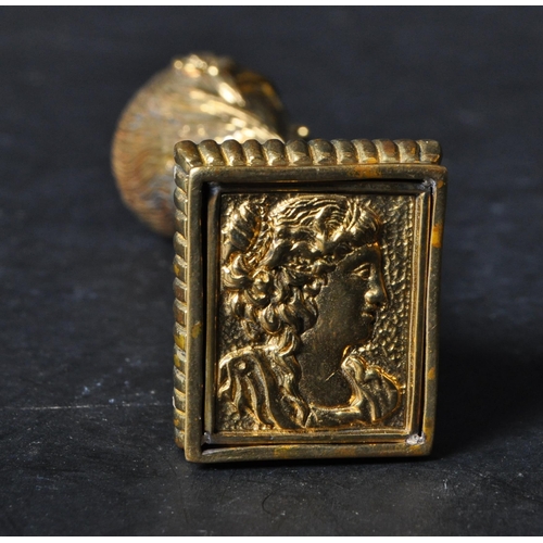 325 - A 20th century Art Nouveau style brass desk seal in the shape of a lady's head. The base decorated w... 