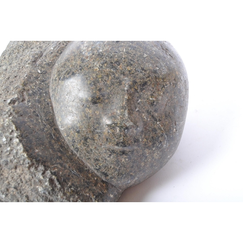 328 - A vintage 20th Century granite stone carving of a child babies face. Measures approx. 22cm x 12cm x ... 