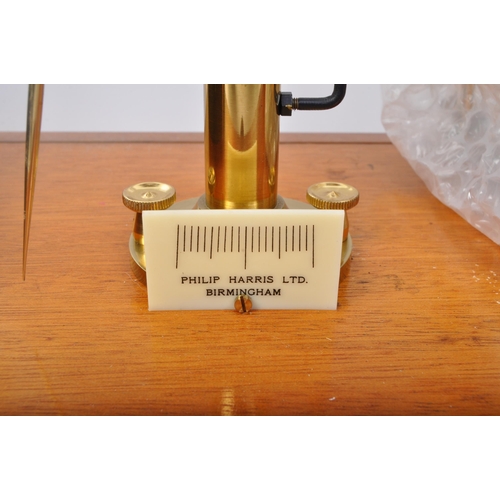 339 - A vintage mid 20th century circa 1960s Philip Harris Ltd precision scale cased in oak & glass displa... 