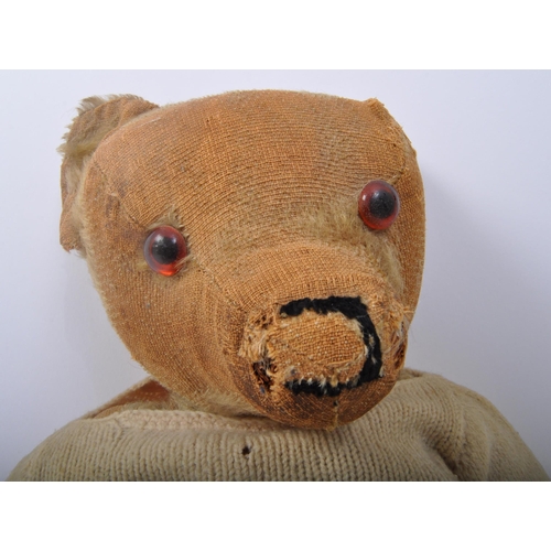 344 - A vintage mid 20th Century Merrythought teddy bear soft toy. Of typical form with wear commensurate ... 