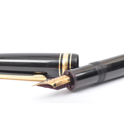 353A - A Montblanc Meisterstuck no. 146 writing ink pen. The pen having a black plastic body with gilt clip... 