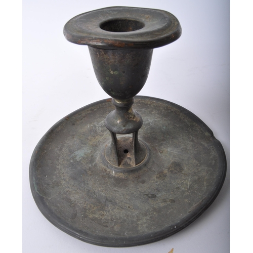 355 - A pair of 19th Century pewter candles holders. One having a flared top with central column with push... 