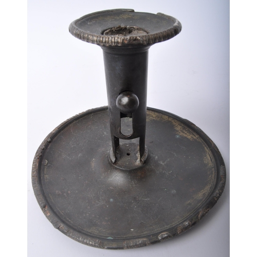 355 - A pair of 19th Century pewter candles holders. One having a flared top with central column with push... 