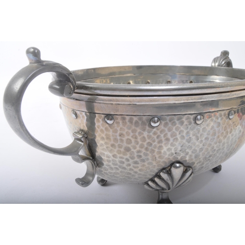 361 - Walker & Co - Homeland - An early 20th century Arts & Crafts hammered pewter twin handled footed cen... 