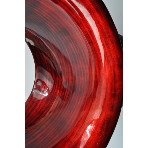 370 - A large contemporary resin free form sculpture. Having an abstract form with red and black striped c... 