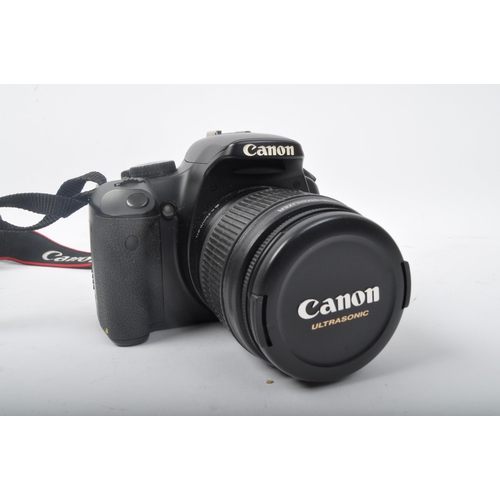 377 - A retro vintage 20th century Canon EOS 450D photographic camera, together with a Canon rechargeable ... 