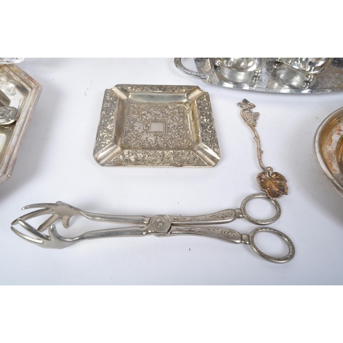 395 - An assortment of 20th century silver plated items to include wine trays, napkin rings, creamers, hot... 