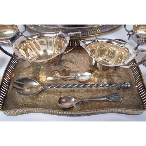 395 - An assortment of 20th century silver plated items to include wine trays, napkin rings, creamers, hot... 