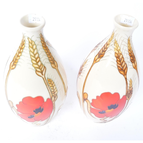 4 - A pair of contemporary Moorcroft Harvest Poppy pattern vase having a bulbous shape. Both marked to b... 