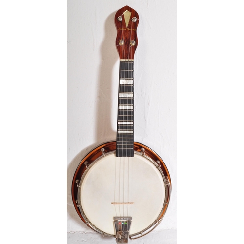 423 - A Banjolele of unknown make with nylon strings, faux  mother of pearl fret inlays, ebonised neck. Ho... 