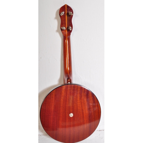 423 - A Banjolele of unknown make with nylon strings, faux  mother of pearl fret inlays, ebonised neck. Ho... 