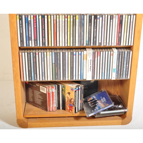 425A - A large collection of approximately 200 CDs within bookcase, largely classical music genre in stand.