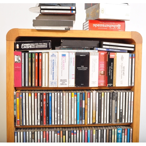 425A - A large collection of approximately 200 CDs within bookcase, largely classical music genre in stand.