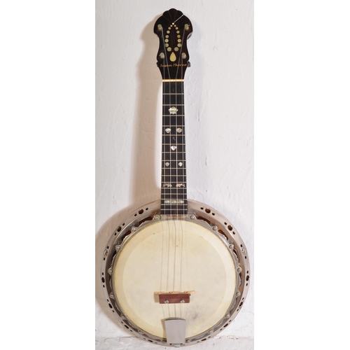 428 - A vintage Supreme Banjolele of unknown make with nylon strings, faux mother of pearl shell & dolphin... 