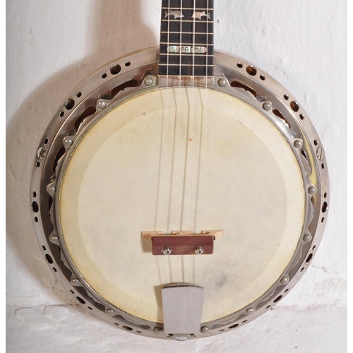 428 - A vintage Supreme Banjolele of unknown make with nylon strings, faux mother of pearl shell & dolphin... 