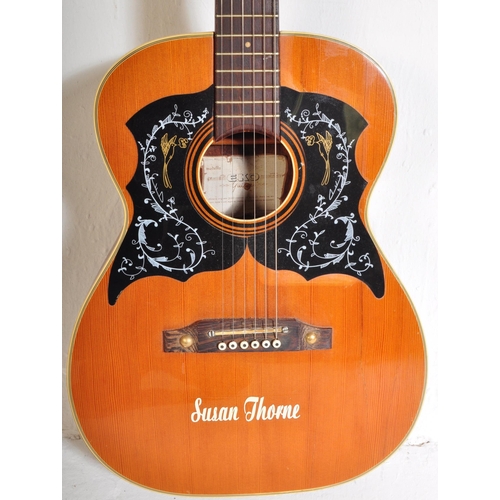 429 - Eko Guitars - A vintage Eko acoustic guitar with a hollow body with decorated ebonised sound holes a... 