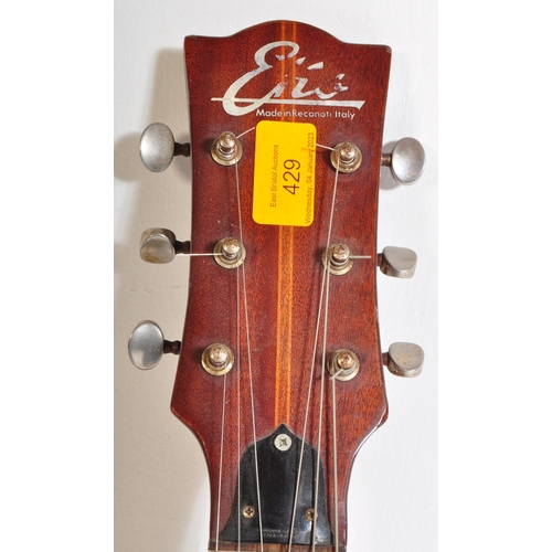 429 - Eko Guitars - A vintage Eko acoustic guitar with a hollow body with decorated ebonised sound holes a... 