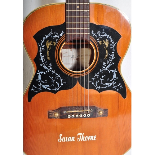 429 - Eko Guitars - A vintage Eko acoustic guitar with a hollow body with decorated ebonised sound holes a... 