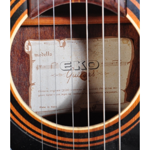 429 - Eko Guitars - A vintage Eko acoustic guitar with a hollow body with decorated ebonised sound holes a... 