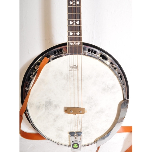 433 - A Barnes & Mullins Banjo. The instrument set up for left handed use, having an decorated head stock ... 