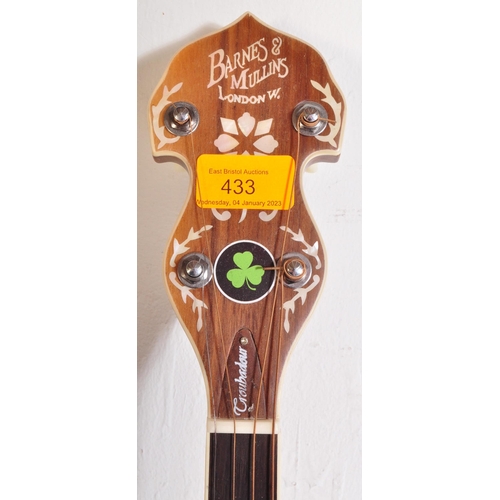 433 - A Barnes & Mullins Banjo. The instrument set up for left handed use, having an decorated head stock ... 