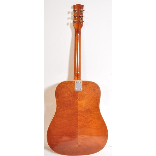 434 - Eko Guitars - A vintage Eko left handed acoustic guitar with a hollow body with brown acrylic pick g... 