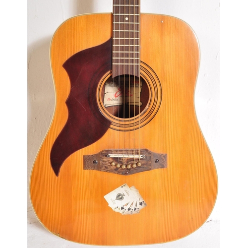 434 - Eko Guitars - A vintage Eko left handed acoustic guitar with a hollow body with brown acrylic pick g... 