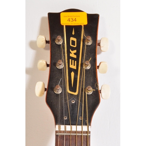 434 - Eko Guitars - A vintage Eko left handed acoustic guitar with a hollow body with brown acrylic pick g... 