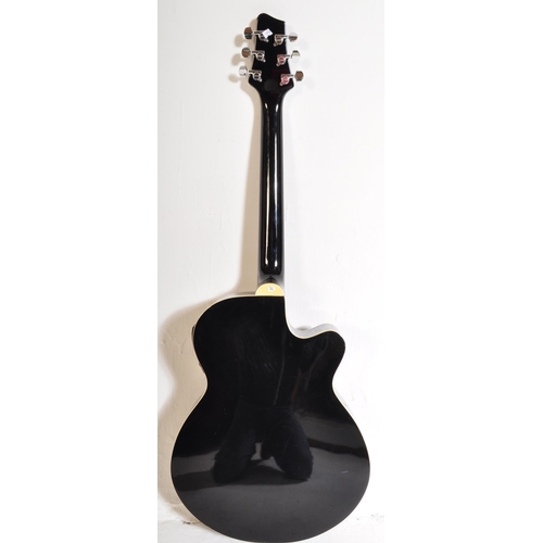 437 - Stagg Guitars - Serial No. 0911/69 - A Stagg left handed electric / acoustic guitar with a hollow bo... 