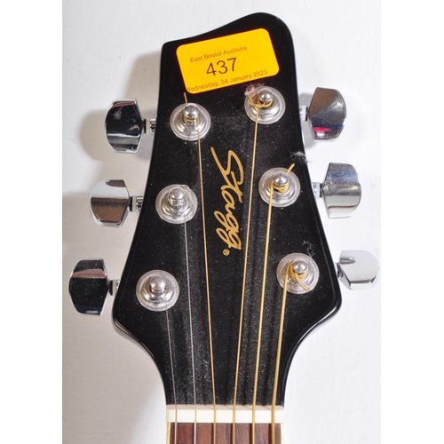 437 - Stagg Guitars - Serial No. 0911/69 - A Stagg left handed electric / acoustic guitar with a hollow bo... 