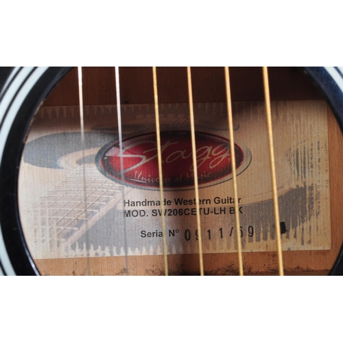 437 - Stagg Guitars - Serial No. 0911/69 - A Stagg left handed electric / acoustic guitar with a hollow bo... 