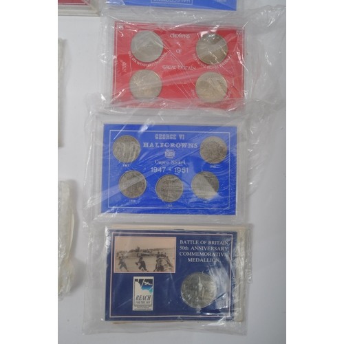 465A - A large collection of vintage 20h century commemorative coins sets. The lot to include two 1970 coin... 