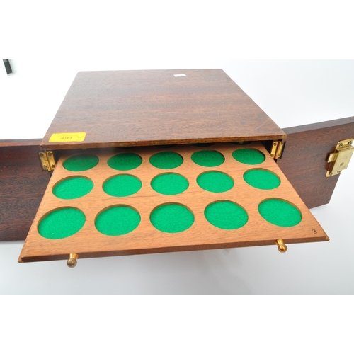 491 - A 20th century mahogany coin collectors display box. The box having twin doors opening to reveal dra... 