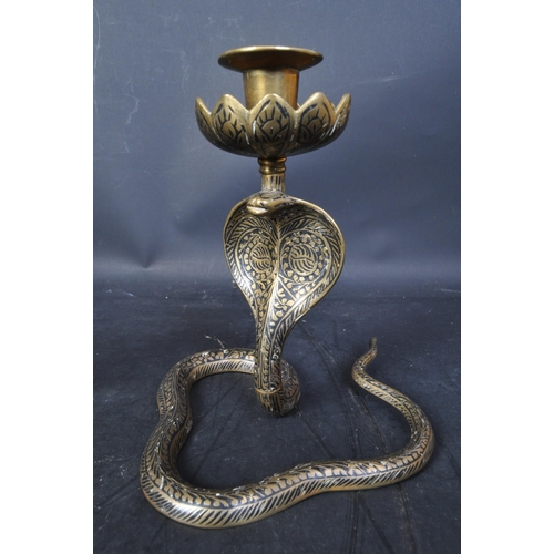 76 - A pair of 20th century Persian brass niello enamelled snake candlesticks. The pair having foliate ar... 