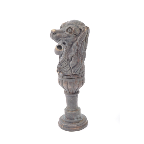 251a - A Victorian style brass seal in the form of a dog smoking a pipe with moulded details. Measures 6.5c... 