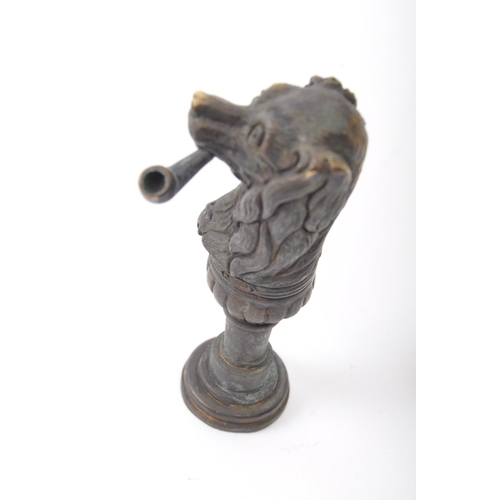 251a - A Victorian style brass seal in the form of a dog smoking a pipe with moulded details. Measures 6.5c... 