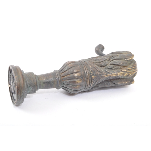 251a - A Victorian style brass seal in the form of a dog smoking a pipe with moulded details. Measures 6.5c... 