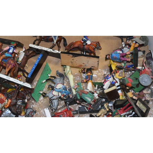 105 - A large collection of assorted vintage lead and plastic toy soldier figurines. Many horse back mount... 