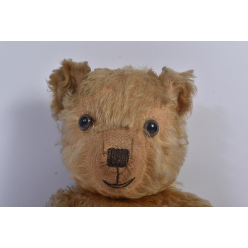 147 - A vintage English soft toy teddy bear, likely Chiltern or Chad Valley. The bear having golden mohair... 