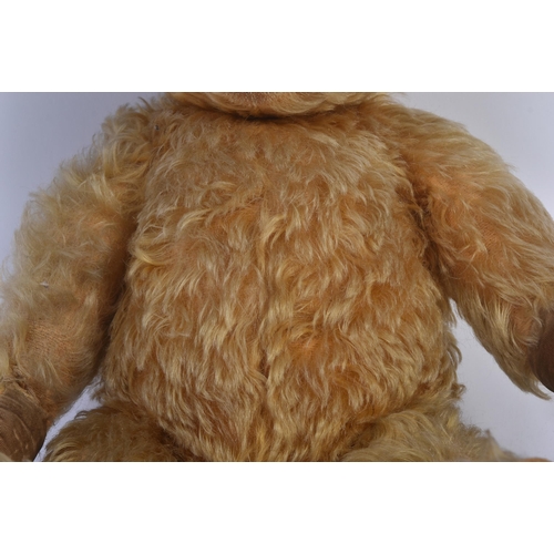 147 - A vintage English soft toy teddy bear, likely Chiltern or Chad Valley. The bear having golden mohair... 