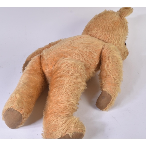 199 - A large vintage English soft toy teddy bear, likely Chiltern or Chad Valley. The bear having golden ... 