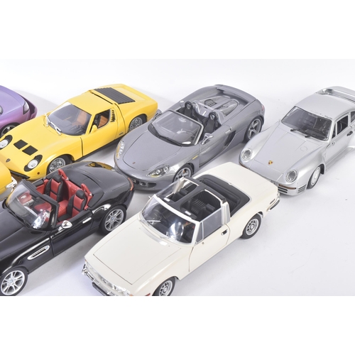 313 - A collection of x10 assorted 1/18 scale loose diecast model cars by makers Maisto, Jadi, Majorette, ... 