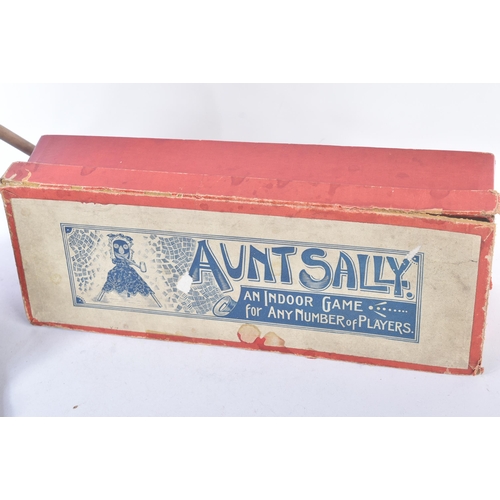 315 - An early 20th Century ' Aunt Sally ' parlour game. Wooden doll with tripod legs, wooden pipe and rub... 