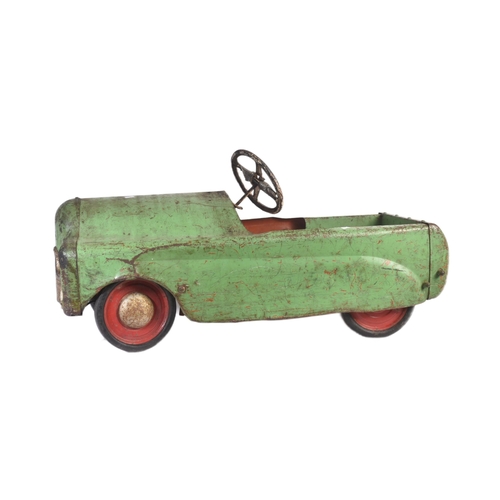 32 - A vintage Triang / Lines Bros tinplate children's pedal car. Green body with wooden drivers seat and... 