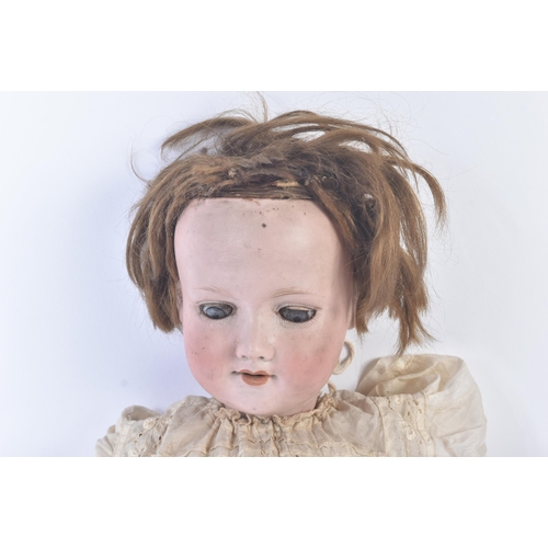 340 - An early 20th Century German ' Armand Marseille ' bisque headed doll with leg walking mechanism. The... 