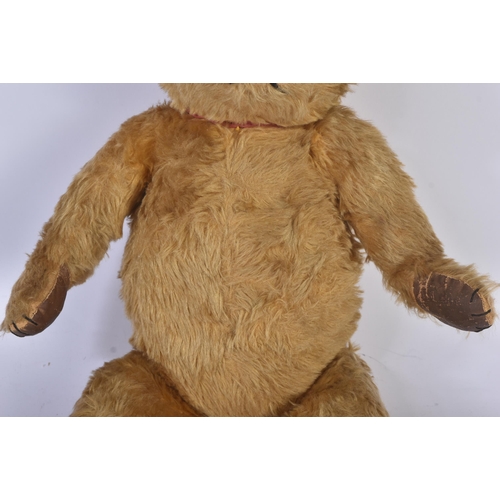 358 - A vintage English, likely Chad Valley or Chiltern made, soft toy teddy bear. The bear firmly stuffed... 