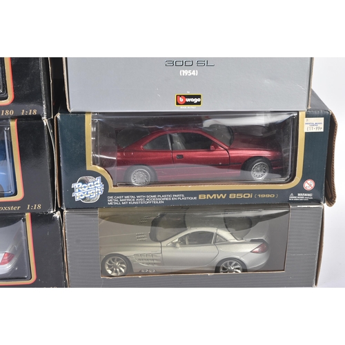 374 - A large collection of assorted 1/18 scale boxed diecast model cars by Maisto, Burago and Welly. Exam... 